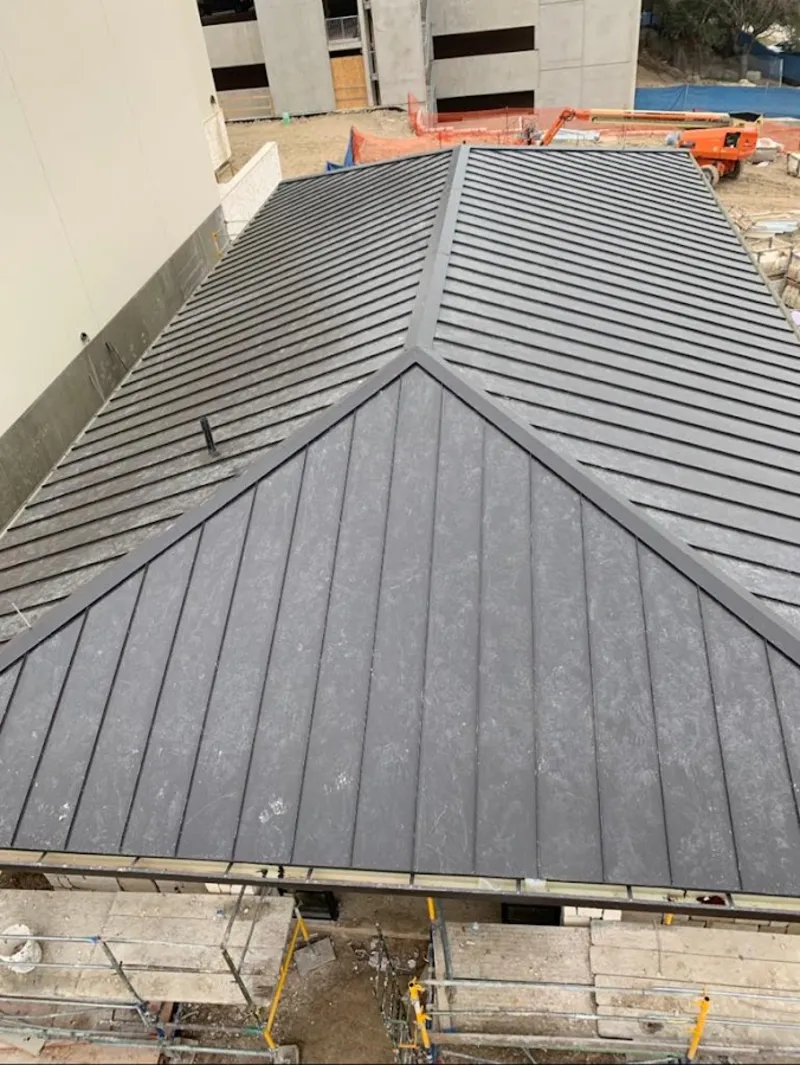 Commercial metal roof construction with crane equipment in East Norriton